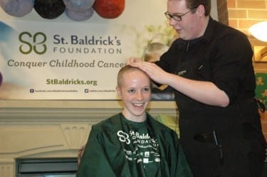 A DMU student shaves her head for cancer research at the 2013 St. Baldrick's Day celebration