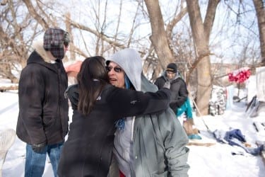 Nisha Fahey embraces her friend, Rhonda. HCO members visit some of the city’s homeless individuals every Sunday morning.