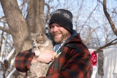 Eric briefly braves the cold with his cat, Camper.