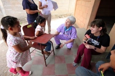 Dr. Rebecca Shaw and Molly Olson, D.O.’16, M.P.H.'16, interact with young patients in a Honduran clinic on last year's spring break service trip.